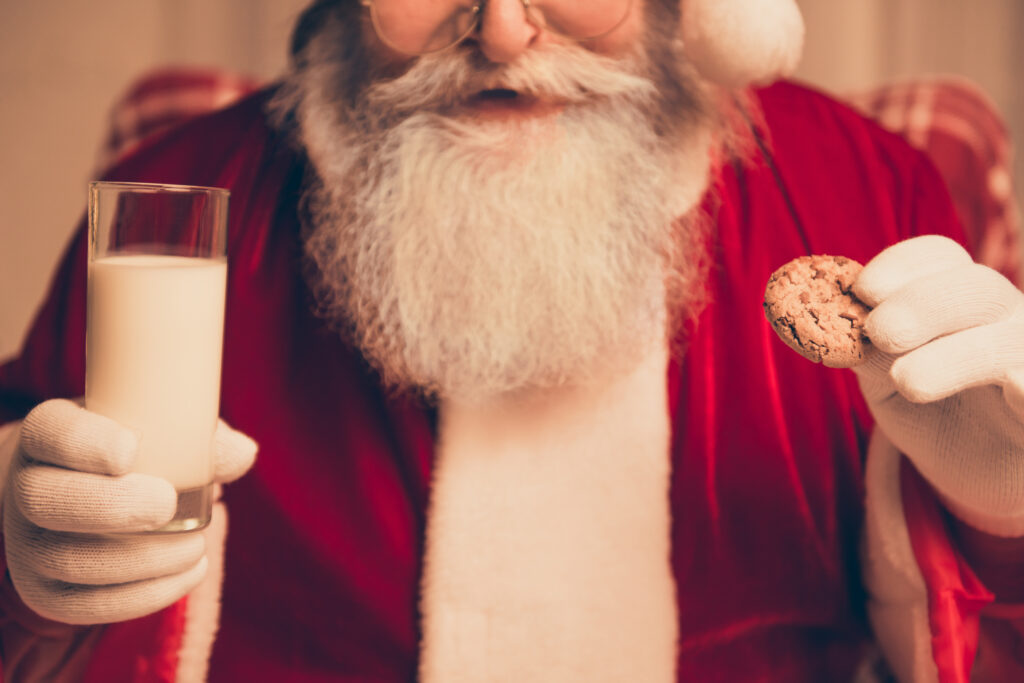 santa claus with milk and cookie Holiday Traditions for Baby’s First Year